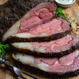 Prime rib roast with three slices and a carving fork