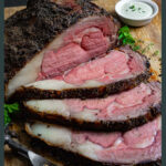 Prime rib roast with three slices and a carving fork